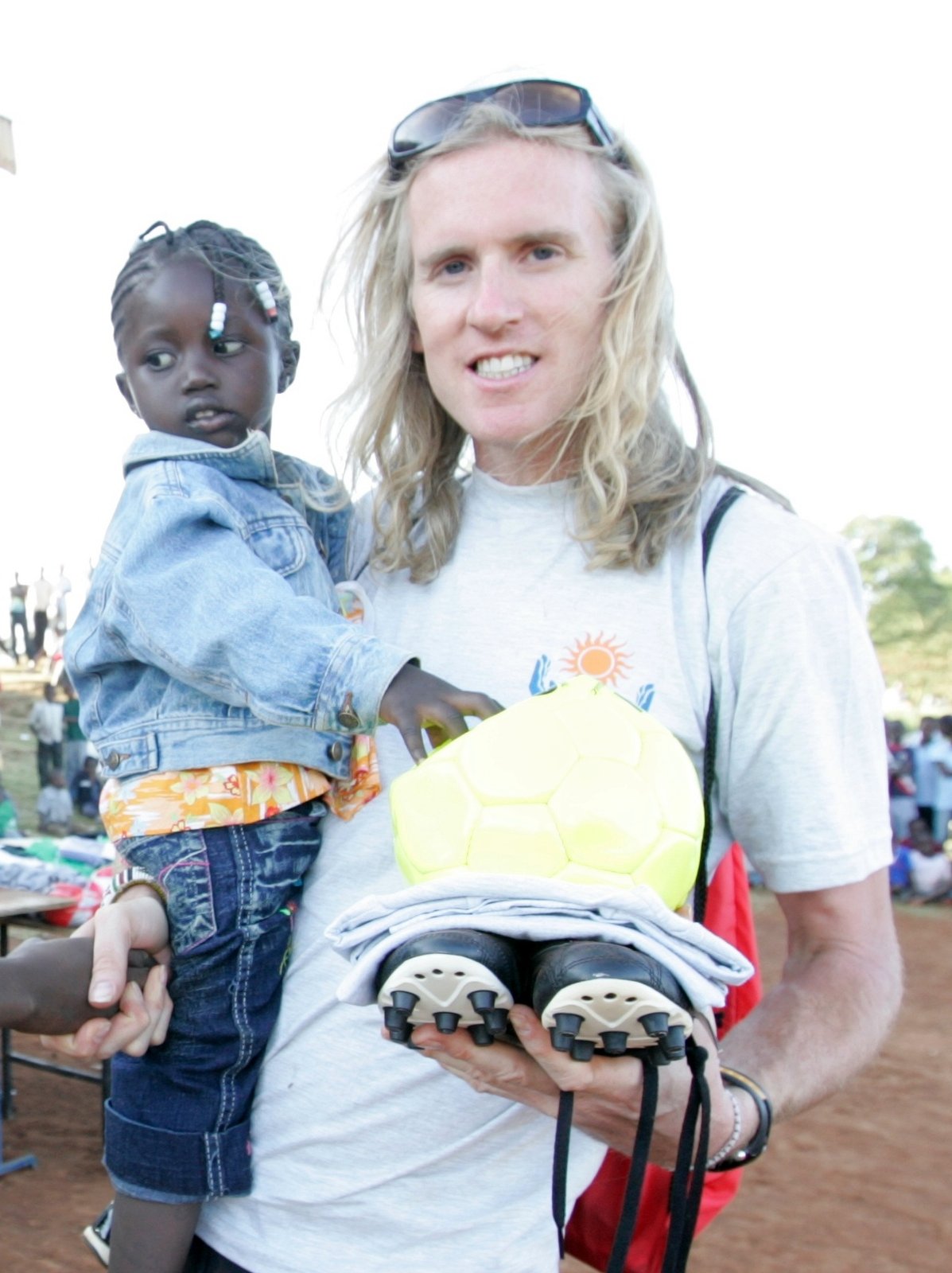 Toby Tanser, SHOE4AFRICA founder, with a child